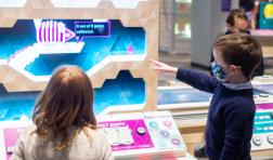 Two kids interact with a museum exhibit
